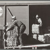 Farmers unload new potato sacks brought by growers' co-operative. Monte Vista, Colorado