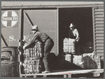 Farmers unload new potato sacks brought by growers' co-operative. Monte Vista, Colorado