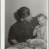 Thomas Beede and small daughter at the dinner table in their home. Western Slope Farms, Colorado