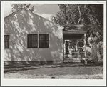 Mrs. Carl Higgins, wife of tenant purchaser, and son on porch of home. Mesa County, Colorado