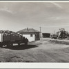 Farmer's truck driving into scale house at sugar beet dump. Adams County, Colorado
