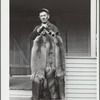 Perley Mosley with three pelts from foxes he trapped. Eden Mills, Vermont