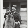 Perley Mosley with three pelts from foxes he trapped. Eden Mills, Vermont