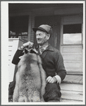 Perley Mosley with three pelts from foxes he trapped. Eden Mills, Vermont