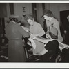 Civilian Defense volunteers receiving instruction in treatment of fractured arm. First aid class. American Red Cross, New York City