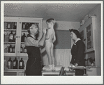 Dr. Tabor examining Randolph Darkey, before inoculating him against measles, in the community health center. Dailey, West Virginia