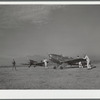 Students wheeling plane into position. Meacham Field, Fort Worth, Texas