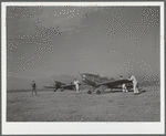 Students wheeling plane into position. Meacham Field, Fort Worth, Texas