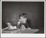 Latin-American child at lunch. Nursery school, FSA (Farm Security Administration) camp. Robstown, Texas