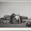 Campers with tractor used in community garden. Robstown FSA (Farm Security Administration) camp, Texas