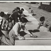 Older boys scrub nursery school cots on Saturday morning. Robstown camp, Texas