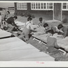 Older boys wash nursery school cots on Saturday morning. Robstown, Texas
