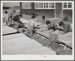 Older boys wash nursery school cots on Saturday morning. Robstown, Texas