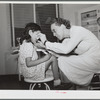 Nurse Doris Dill with young patient. Robstown, Texas