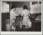 Family preparing tortillas for supper. Robstown camp, Texas