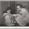 Robstown, Texas. FSA (Farm Security Administration) migratory workers camp. Young patient treating injury under supervision of a nurse