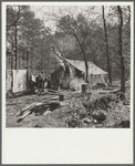 Tent occupied by sharecropper family now living in a migrant camp near Birmingham, Alabama. Note water supply at right
