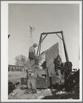 Unloading corn into elevator for storage in crib. Grundy County, Iowa