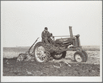 Fred Wilfang, rehabilitation client, uses modern tractor bought with FSA (Farm Security Administration) loan. Black Hawk County, Iowa