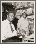 Roy Innis, and unidentified woman, developing pictures for Austin Hansen in studio on 135th Street, Harlem