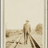 Portrait of Arthur Schomburg standing on railroad track
