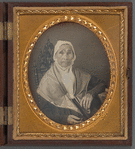 Portrait of an older woman sitting in gothic-style chair