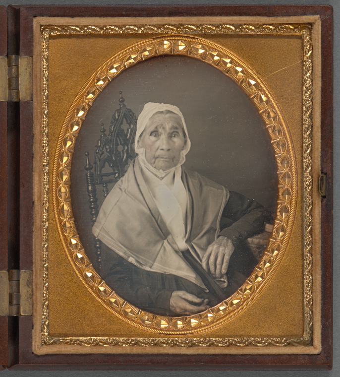 Digital representation of a daguerreotype portrait of an elderly woman sitting in gothic-style chair