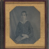 Portrait of a young woman with book in lap