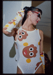 Model on runway wearing Patrick Kelly Paris bathing suit and gloves, in golliwog pattern print, from Summer 1986 collection