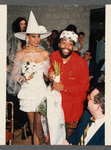 Fashion designer Patrick Kelly, and model wearing white dress and hat, at fashion event in Paris
