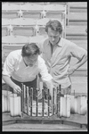 Ming Cho Lee and Joseph Papp conferring before set model for the stage production Troilus and Cressida during rehearsal at the Delacorte Theater