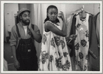 Patrick Kelly with model, the latter wearing dress in golliwog print