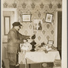 John Dudeck lighting a lamp in his home. Dalton, New York, Allegany County