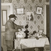 John Dudeck lighting a lamp in his home. Dalton, New York, Allegany County