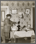 John Dudeck lighting a lamp in his home. Dalton, New York, Allegany County