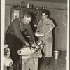 Frank Walker, farmer cutting meat in his farm home near Dalton, New York