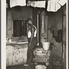 Steel worker in kitchen of slum apartment. Midland, Pennsylvania