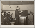 Preacher conducting hymn singing. Pentecostal church, Cambria, Illinois