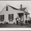 The Bollinger family in front of their home. Decatur Homesteads, Indiana