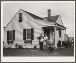 The Bollinger family in front of their home. Decatur Homesteads, Indiana