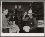 Farmer buying a new hat in the store at Blankenship, Indiana