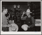 Farmer buying a new hat in the store at Blankenship, Indiana
