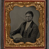 Portrait of Black Man in a Dark Suit and Tie, Holding Book