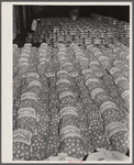 Sacks of onions and baskets of apples at produce market on Pier 29. New York City