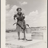 Farm girl pumping water. Fairfield Bench Farms, Montana, [Teton County,] Montana