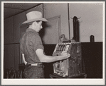 Dude playing a slot machine. Birney, Montana