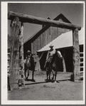Dudes riding through corral gate. Quarter Circle 'U' Ranch, Montana
