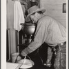 Cowhand operating cream separator. Quarter Circle 'U' Ranch, Montana