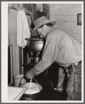 Cowhand operating cream separator. Quarter Circle 'U' Ranch, Montana