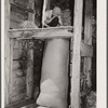 Stuffing bag of wool. Rosebud County, Montana. Sheep shearing pen